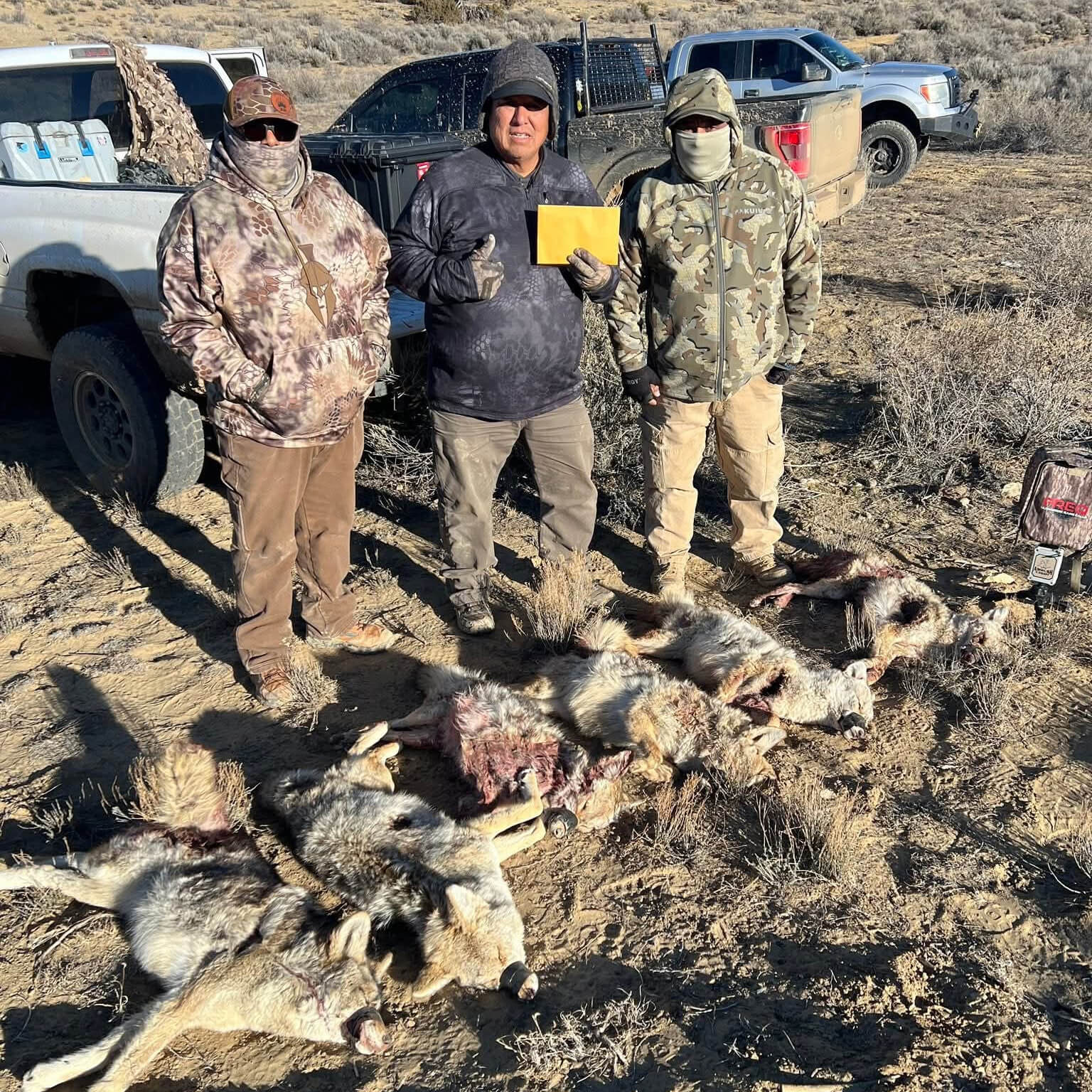 Christopher Yazzie, Lyndon Honwytewa and Vann Litson with six coyotes after winning the Eastern Navajo Nation Coyote Contest.