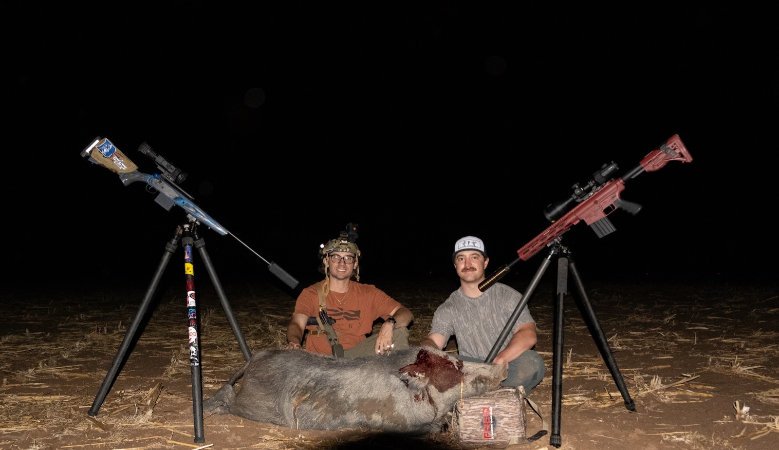 Two hunters with a wild hog called in with the FREQ ultrasonic game call at night