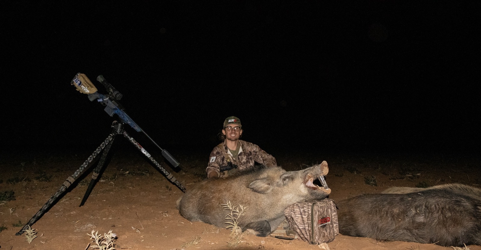 Hunter with two wild hogs taken on one FREQ stand